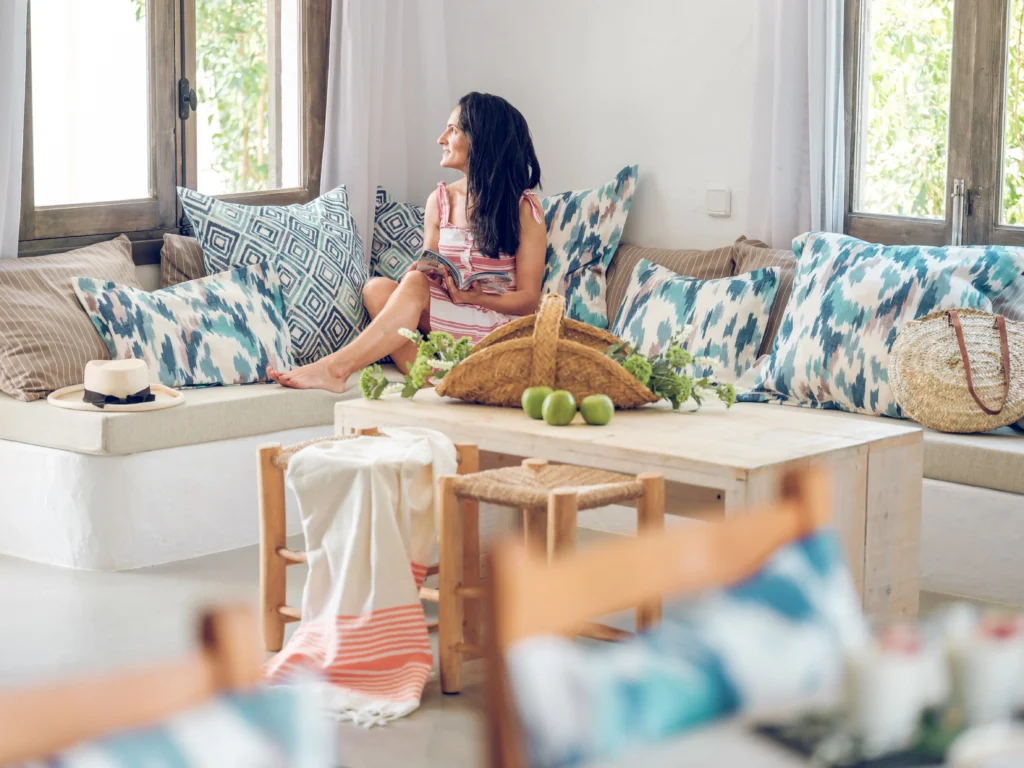 Woman relaxing in a custom-designed cozy living room filled with natural light